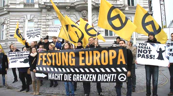 Far-right activists at an Identitarian Movement of Austria anti-immigration rally in Vienna. The German-language signs read "Fortress Europe", "Close the Borders Now!", "My Home is Not an Immigrant Country", and "Europe, Youth, Reconquista".