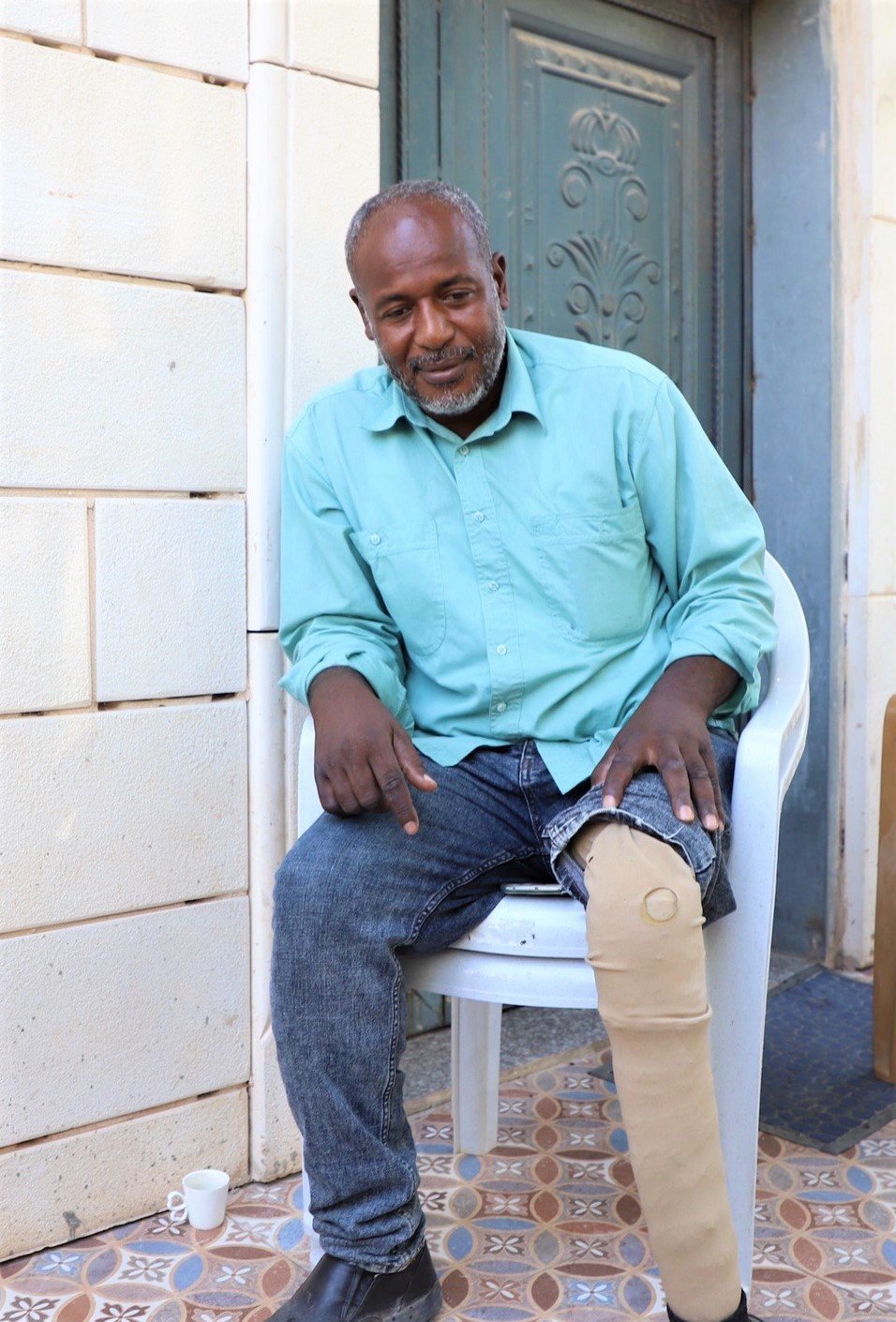 Joma'a Abu-Jabal shows the prosthetic leg he uses after Israeli forces shot his leg which was later amputated
