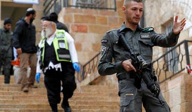 Israeli security forces clear the way for first responders transporting a dead body from the scene of a shooting in the old city of Jerusalem on November 21, 2021.